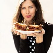 Jenny Goldfarb holding an Unreal Deli sandwich!