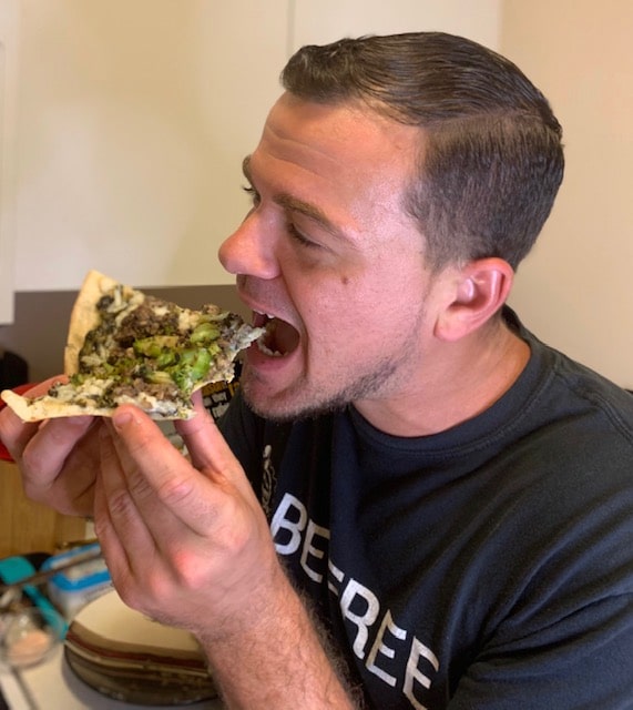 Wess eating vegan pizza