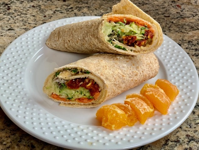The plated hummus and sun-dried tomato wrap