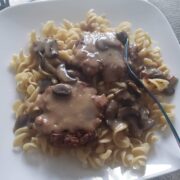 vegan steak and mushroom sauce over noodles