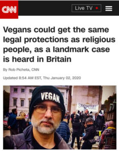 Screen capture of a CNN webpage with a photo of a man with a vegan beanie