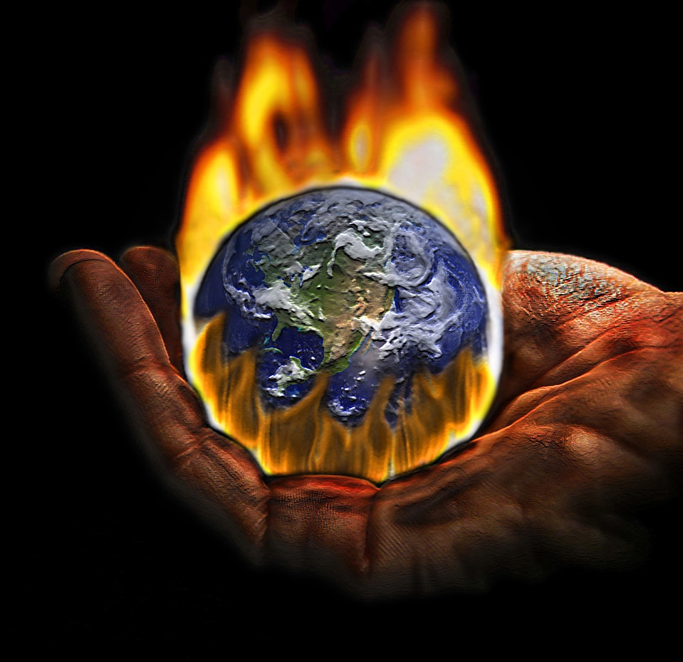 Planet earth burning being hold by two hands