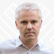 Man wearing a shirt looking at the camera