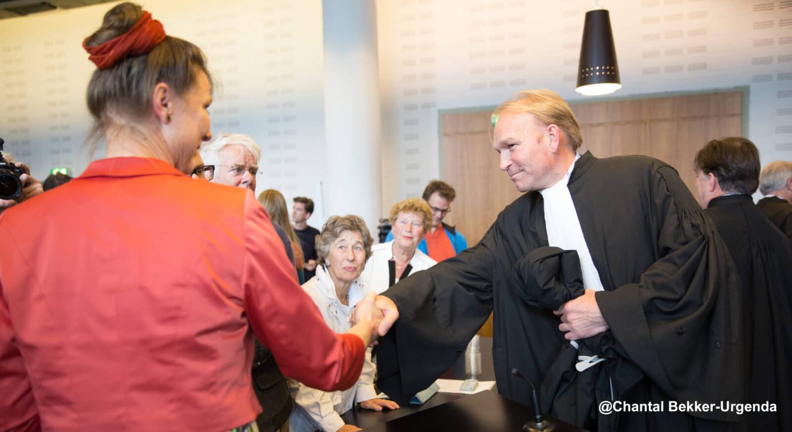 Woman shaking hands with a Dutch lawyer in Court