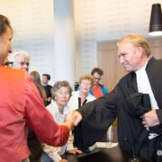 Woman shaking hands with a Dutch lawyer in Court