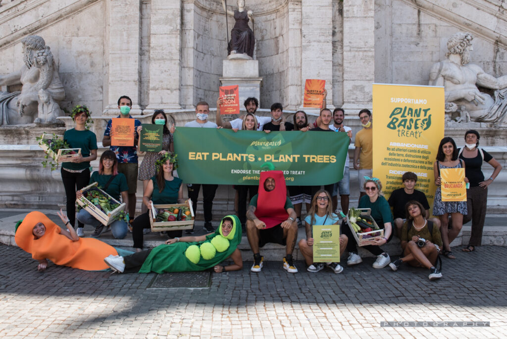 Activist with placards and banners demonstrating in Italy for the Plant Based Treaty