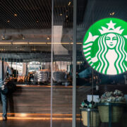 Starbucks coffee logo in front of the shop. By wachiwit via Adobe Stock