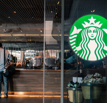 Starbucks coffee logo in front of the shop. By wachiwit via Adobe Stock