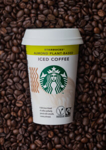 Paper cup of Starbucks Almond plant based iced cold coffee. By DenisMArt via Adobe Stock