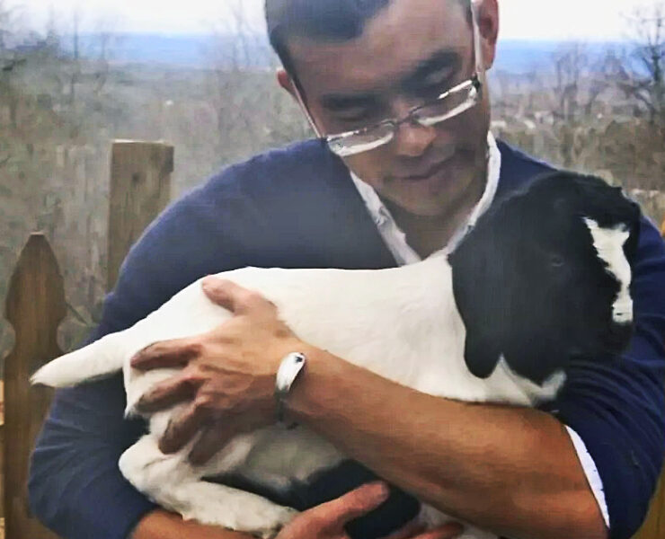 Animal Rights Activist Wayne Hsiung holding rain the goat