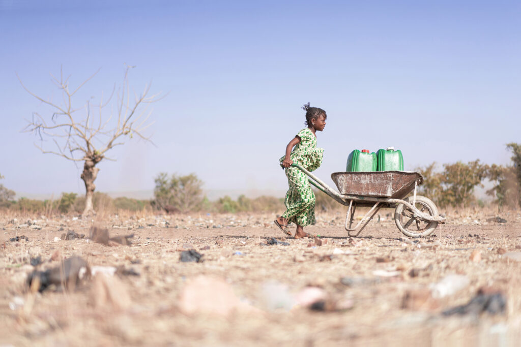 Little African Woman Transporting Fresh Water as a drought 