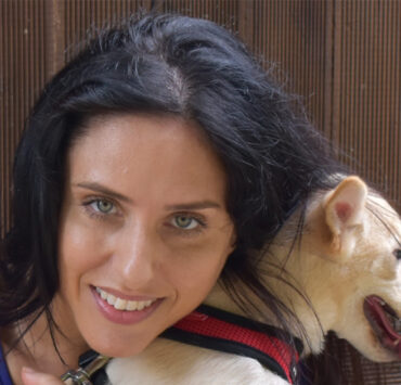 Nina Jackel from Lady Freethinkers hugging a dog