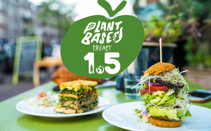 Plant Based Treaty 1.5 logo with vegan food in city background