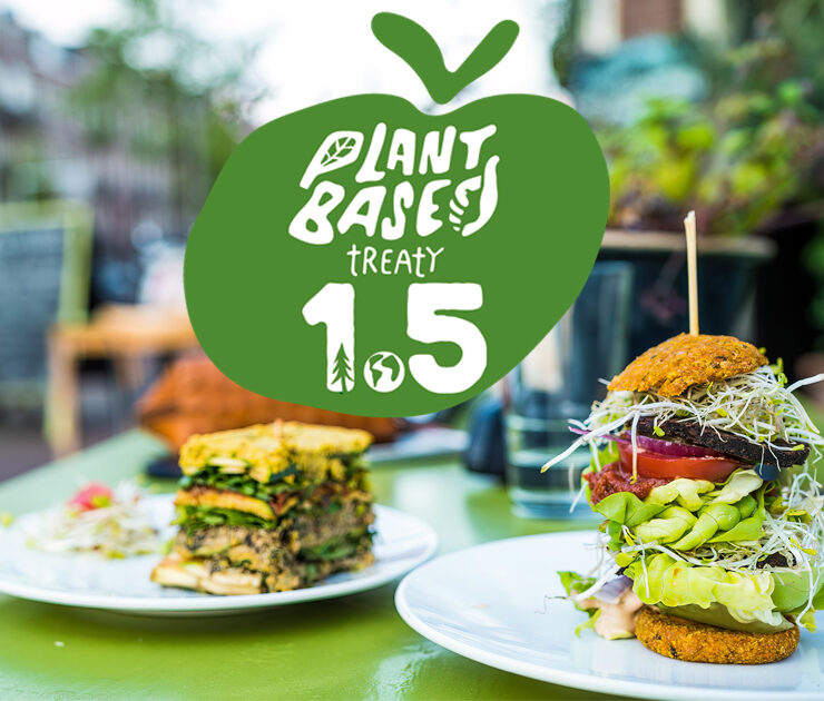 Plant Based Treaty 1.5 logo with vegan food in city background