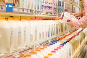 Woman checking ingredients on plant-based milk alternatives