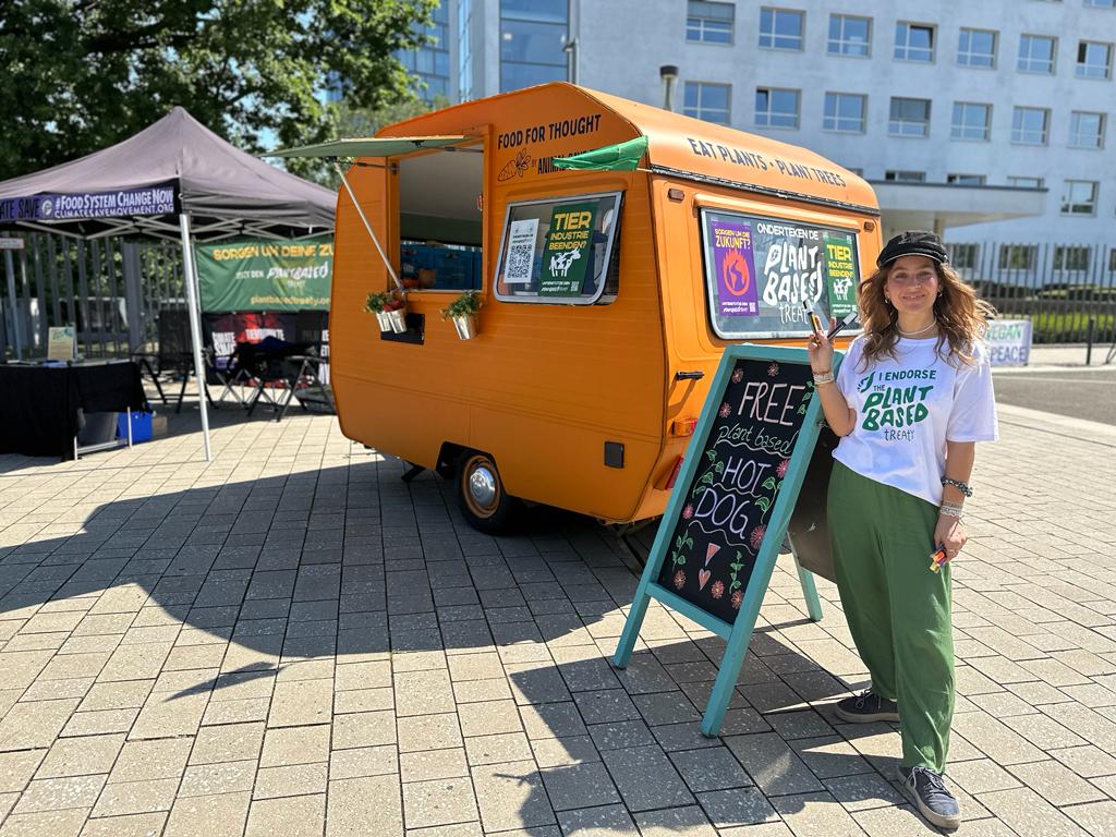 Plant Based Treaty Campaigner Lena Ella with the Food for Thought vegan truck at the Bonn Climate Conference
