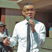 Wayne Hsiung speaking to SxE supporters after a hearing of the trial