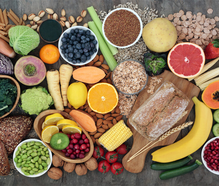 High-fibre super food with whole grain bread loaf and rolls, fruit, vegetables, whole wheat pasta, cereals, seeds and nuts.